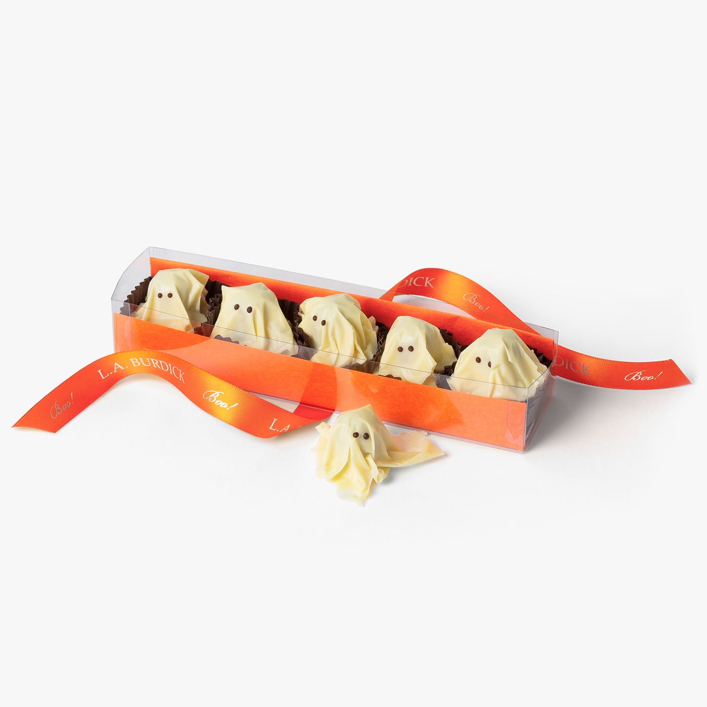White chocolate covered ghosts nestled in packaging and tied with an orange ribbon for Halloween